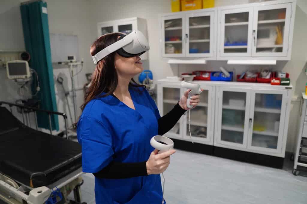 Woman in scrubs using VR headset